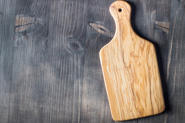 Wooden Cutting Board with Fresh Herbs and Raw Vegetables on Rustic Wood Table. Top view. Cooking background.