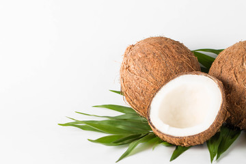 Ripe half cut coconut on a wooden background. Coconut cream and oil.
