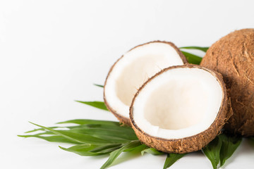 Ripe half cut coconut on a wooden background. Coconut cream and oil.
