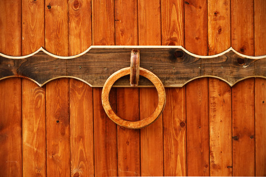 Wooden entrance gate with round knocker handle