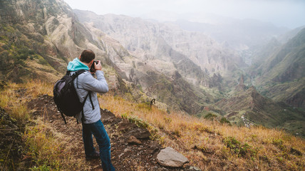 Fototapeta na wymiar Santo Antao Island, Cape Verde. Travel hiker photographing Xo Xo valley and terrain mountain landscape