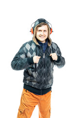 a young man in headphones in a jacket and orange pants looks and smiles at the camera. Isolated