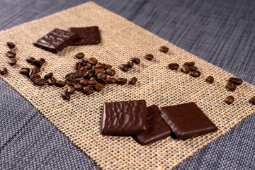 coffee beans and chocolate on burlap background