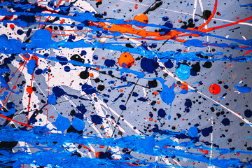 Picture painted using the technique of dripping. Mixing different colors blue red white black. A riot of color. Lines and spots. Horizontal orientation.