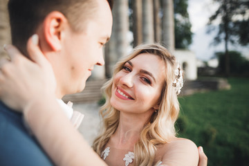 Fototapeta premium Gorgeous happy couple standing close to each other and looking in eyes