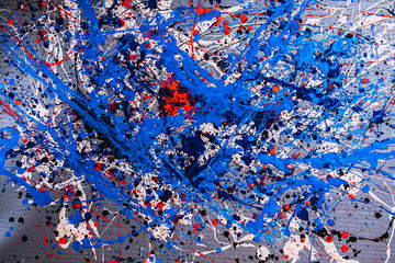 Picture painted using the technique of dripping. Mixing different colors blue red white black. A riot of color. Lines and spots. Horizontal orientation.