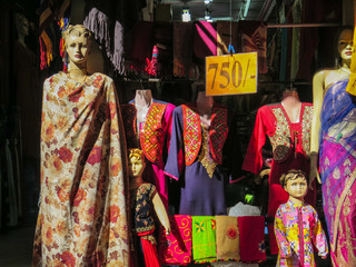 Woman and child mannequin wearing traditional nepali clothes in a street market store in Kathmandu, Nepal