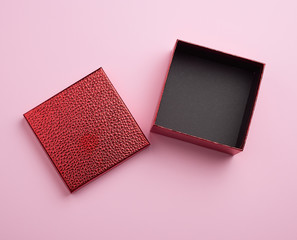 open red square cardboard empty box, item lies on a pink background color
