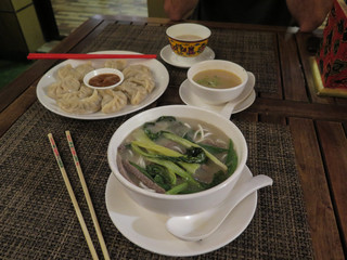 Momos, noodles, chopsticks and butter tea in a Tibetan restaurant in Kathmandu, Nepal