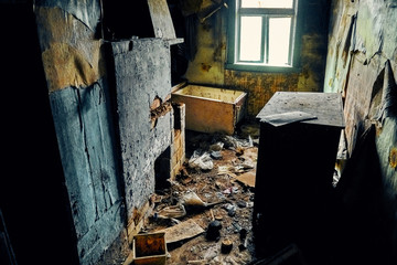 A terrible mysterious apocalyptic view: an abandoned house in the abandoned Belarusian Kovali (Belarusian: blacksmiths) village - no one lives here anymore - interior: scattered things