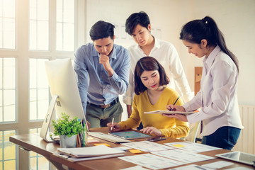 Group of Young asian Designers drawing website ux app development on mobile phone.