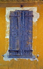 A colourful wooden shuttered window on a building in Provence France