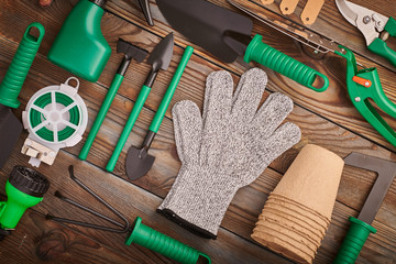 Gardening tools on wooden background flat lay
