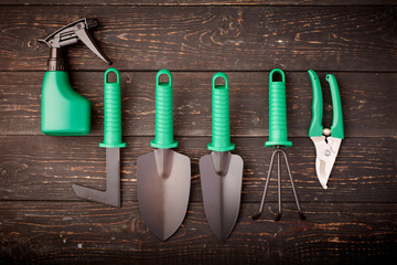 Gardening tools on wooden background flat lay