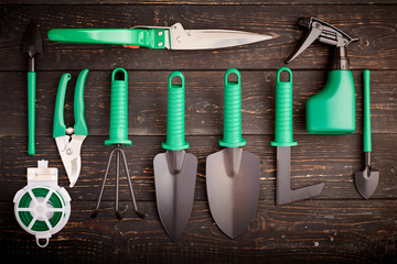Gardening tools on wooden background flat lay
