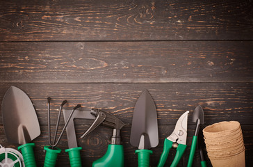 Gardening tools on wooden background flat lay