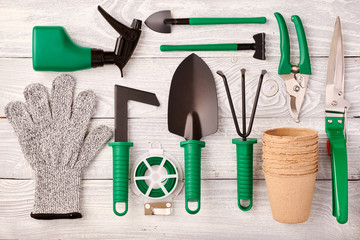 Gardening tools on wooden background flat lay