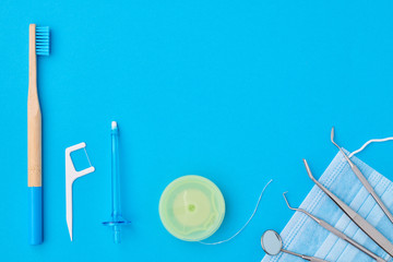 Dentist tools over blue background top view