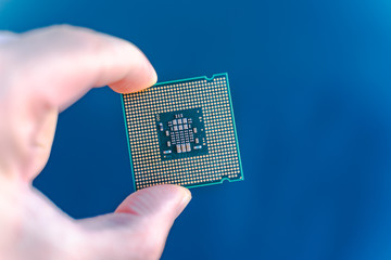 Hand holding CPU.  desktop CPU,  processoor. Informatic chip, PC component. Micro chip.