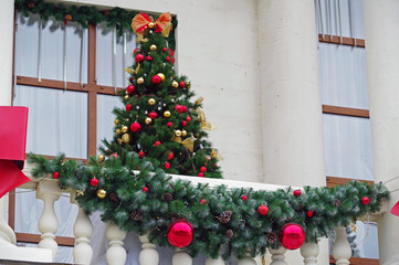 Stylish christmas decorations on the balcony of the house