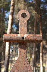 old rusty metal figure in background