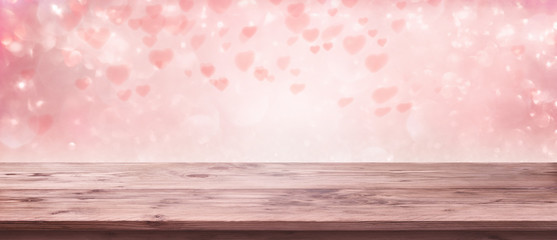 Flying pink hearts with wooden table