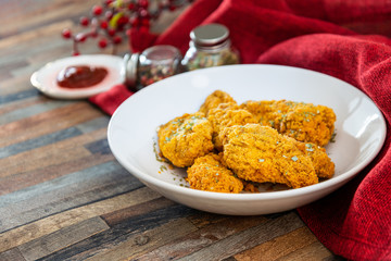 Chicken Wings Spicy chicken wings, breaded, fried, cooked.