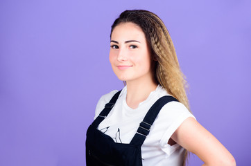 Popular look. Woman smiling face posing with stylish hairstyle on violet background. Hair crimping...