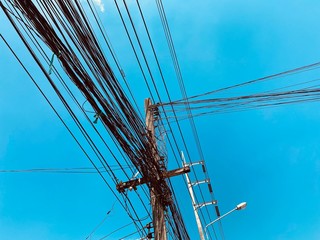 busy electric wire on the street in the city on a background of blue sky