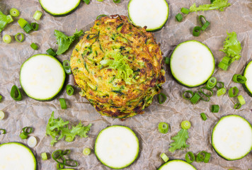 Zucchini pancakes with chives on a wooden table. - 313609875