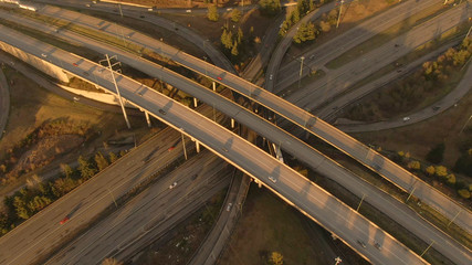 AERIAL Spectacular drone view of a bustling interstate turnpike on sunny evening