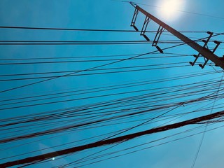 busy electric wire on the street in the city on a background of blue sky