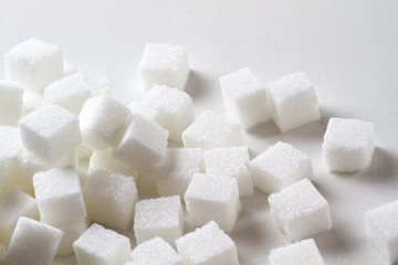 high key Closeup of a Pile of sugar cubes randomly arranged on a white background