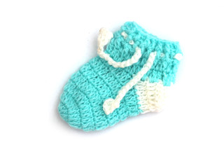 Handmade sweet baby booties isolated on white background