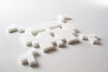 pixel art skull made out of sugar cubes on a white background symbolizing unhealthy food