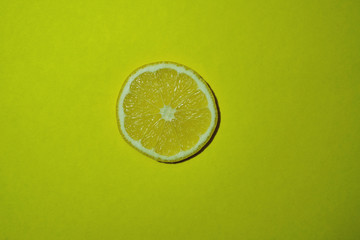 slice of lime on yellow background