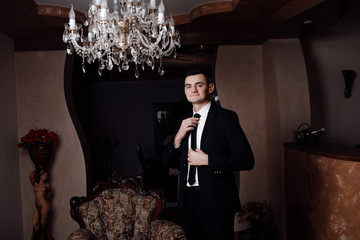 Morning groom in the room. Wedding photography. Groom getting ready in the room for wedding day....