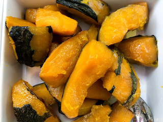 Thai style Pumpkin boiled with syrup in a white plate.