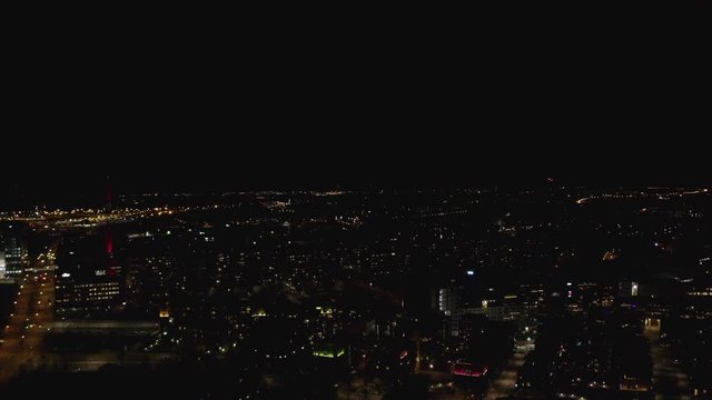 Aerial drone view of night city lights and fireworks.