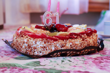 Torta di compleanno alla frutta con candeline 61 anni 