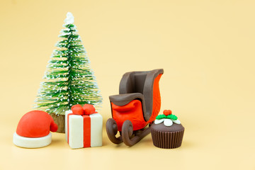 Santa claus sleigh with gift box and cupcake