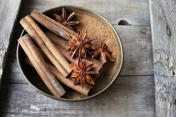 Cinnamon and anise on wooden background