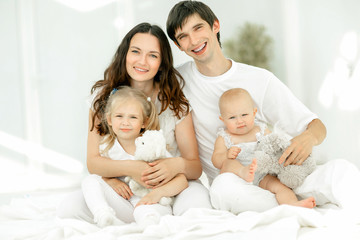 Obraz na płótnie Canvas background image of a young happy family.