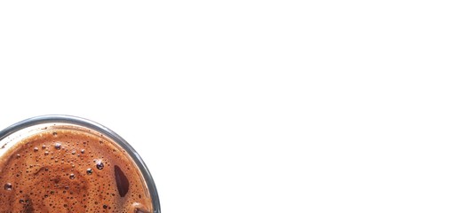 Coffee mug with brown foam inside and a white background for the text. White empty space for your design. Top view coffee.