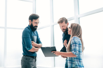 group of business people discussing something in the office corridor