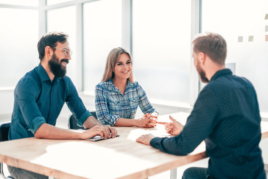 managers and job seeker sitting at the table during the interview