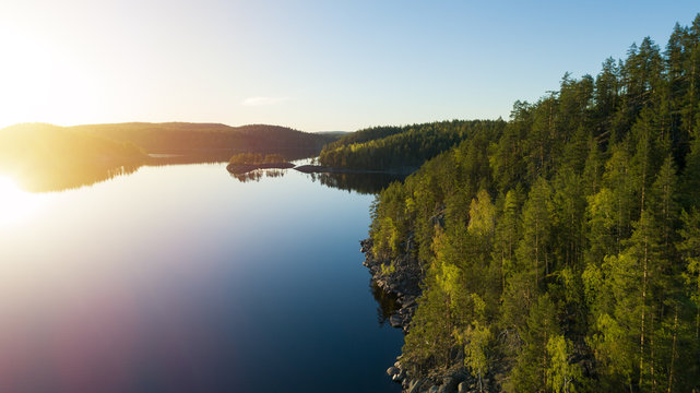 Aerial panorama of beautiful lake, islands and green forest at sunset. Kolovesi, Finland