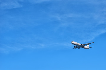 The plane flying in the sky a close up the bottom view