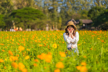 Naklejka na ściany i meble Young woman relaxing in the marigold field