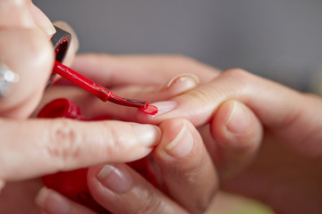 Applying manicure at nail salon 